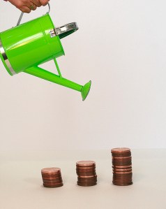 Green watering can that waters money coins